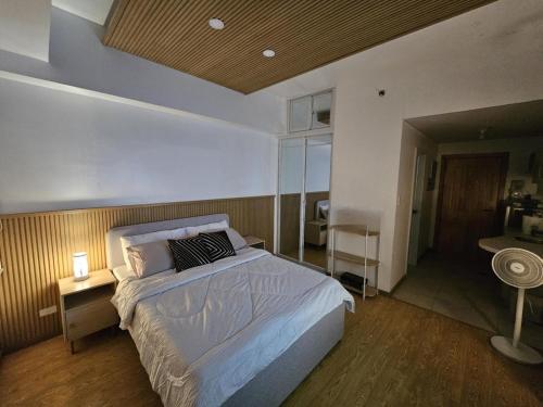 a bedroom with a large bed and a desk at CedarPeak319 in Baguio