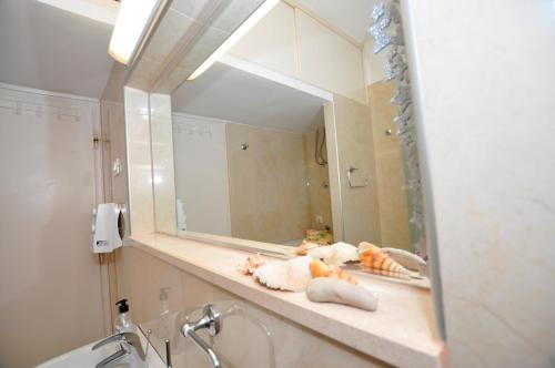 a bathroom counter with a mirror and a sink at Apartment Balcony in Split