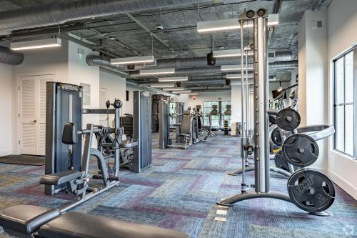 a fitness room with treadmills and machines at Views from ATL Beltline in Atlanta