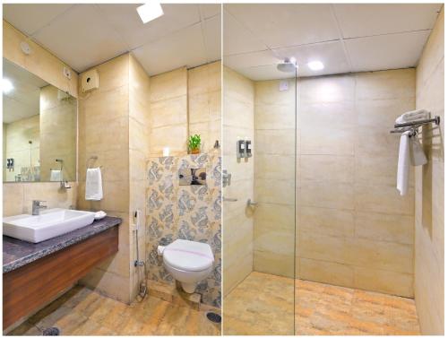 a bathroom with a toilet and a glass shower at Hotel Royale Hills By RSP Vista Hotels & Resorts in Rishīkesh
