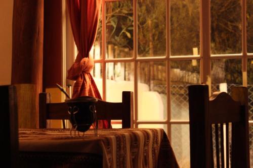 a table with a table cloth and a window with a view at Cabañas Maimará in Maimará