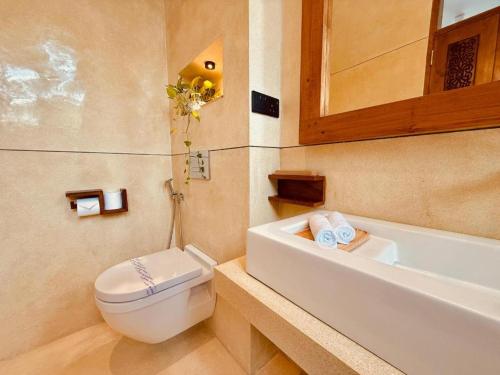 a bathroom with a toilet and a sink and a tub at Madiha Venus in Matara