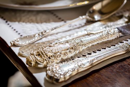 a group of silver utensils sitting on a table at Thorngrove Manor in Stirling
