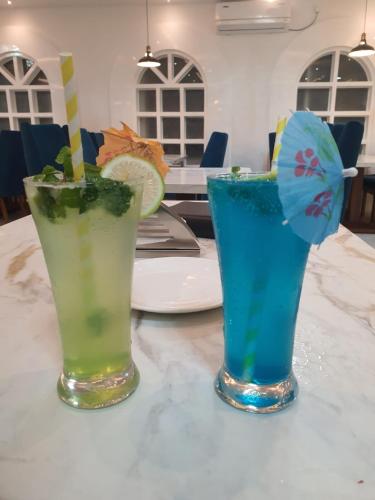 two cocktails sitting on top of a table at HOTEL DEO VOLENTE in Sivasagar