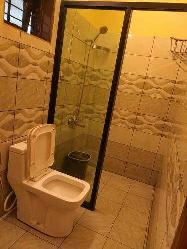 a bathroom with a toilet and a shower at Athirapilly Ontherocks in Athirappilly
