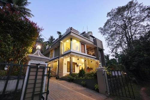 a house with a gate in front of it at Athirapilly Ontherocks in Athirappilly