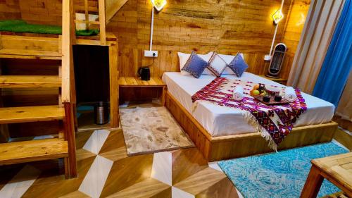 a bedroom with a bed in a wooden room at The Luxe Cascades JIbhi in Jibhi