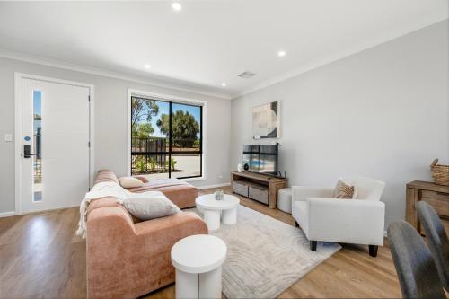 a living room with two couches and two chairs at Whispering Vines in McLaren Vale