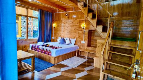 a bedroom with a bed and a staircase in a room at The Luxe Cascades JIbhi in Jibhi