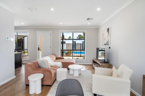 a living room with a couch and a table at Whispering Vines in McLaren Vale