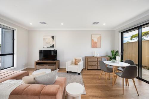 a living room with a couch and a table at Whispering Vines in McLaren Vale