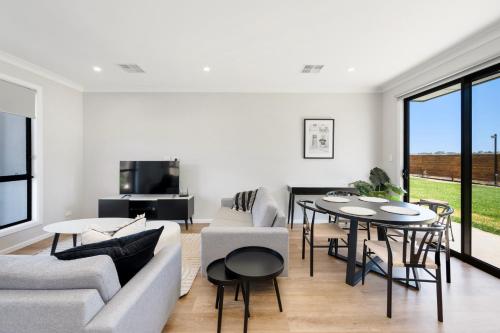 a living room with a couch and a table at Whispering Vines in McLaren Vale