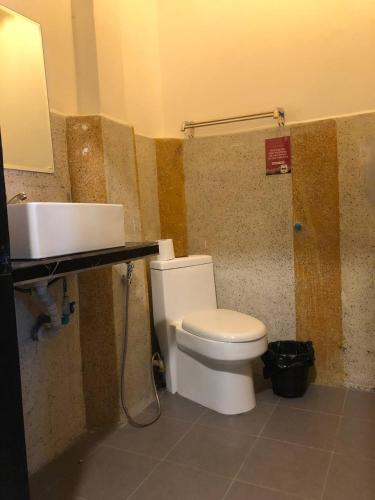 a bathroom with a white toilet and a sink at Bat Chum Villa in Phnom Penh