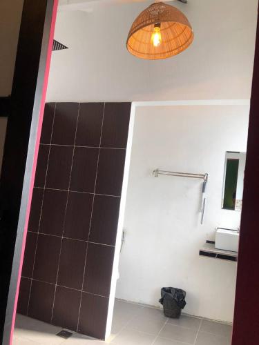 a bathroom with a black and white wall and a light at Bat Chum Villa in Phnom Penh