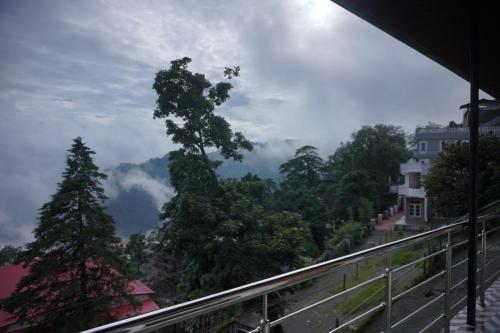 a view of the mountains from a balcony at Sangam by Stotrak, Jhula Ghar Mussoorie in Mussoorie