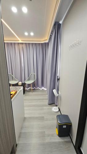 a room with a hallway with purple curtains at Saga Village Hotel & Resort Bintan in Pulau Sekerah