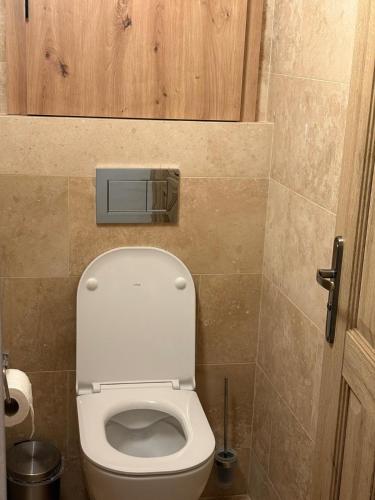 a bathroom with a toilet with the lid up at Apartmány Skalica in Skalica