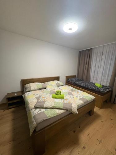 a bedroom with a bed and a window at Apartmány Skalica in Skalica