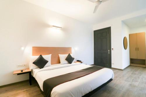 a bedroom with a large bed in a room at Townhouse Noida Sector 71 Near ISKCON Temple Noida in Indirapuram