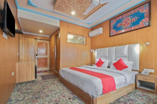 a bedroom with a large bed and a television at The Countryside Stays in Srinagar