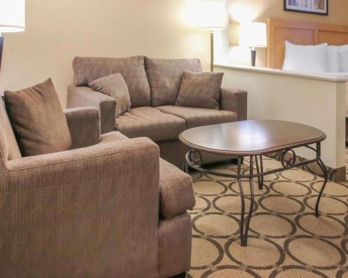 a living room with a couch and a table at Comfort Inn South in Winnipeg