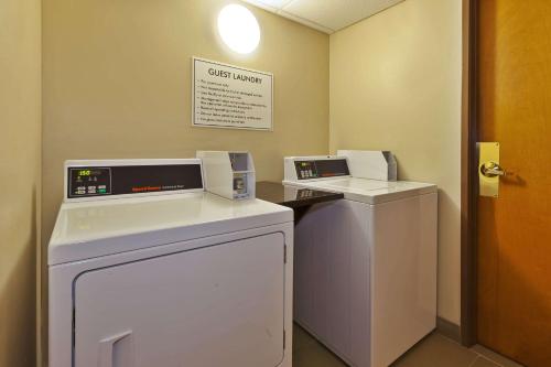 a laundry room with two machines and a washer and dryer at Comfort Inn & Suites in Taylor