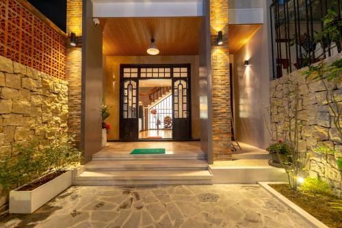 a hallway of a home with a stone wall at Su'e homestay in Hue