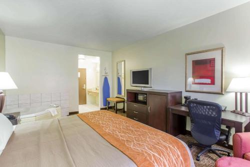 a hotel room with a bed and a desk and a tv at Comfort Inn Franklin Highway 96 in Franklin