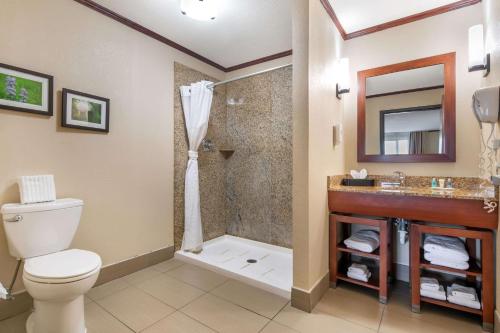 a bathroom with a toilet and a shower at Comfort Suites Manhattan in Manhattan