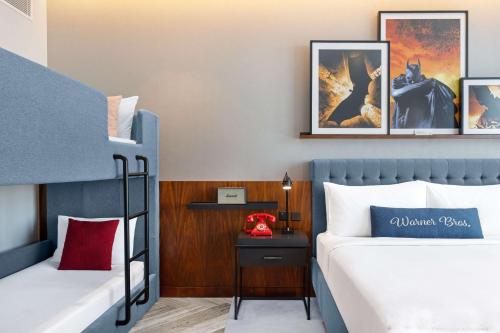 a bedroom with two bunk beds and a side table at The WB Abu Dhabi, Curio Collection By Hilton in Abu Dhabi