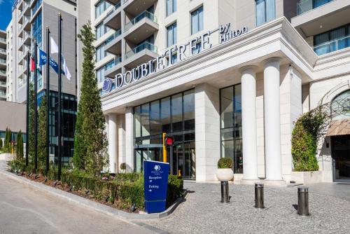 安曼Doubletree By Hilton Amman Hotel & Residences的正面有标志的建筑物