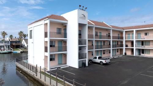 a large apartment building with a parking lot at WindWater Hotel and Marina in South Padre Island