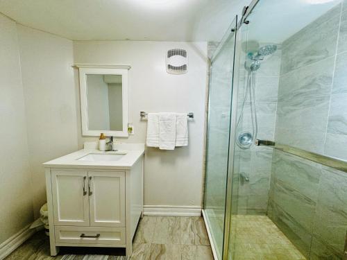 a bathroom with a sink and a shower at Spacious and Modern Family-Friendly 2-Bedroom Apartment - Near Airport & Toronto Downtown in Brampton