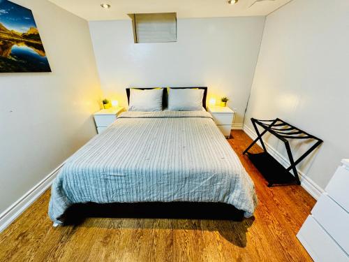 a bedroom with a bed and two night stands at Spacious and Modern Family-Friendly 2-Bedroom Apartment - Near Airport & Toronto Downtown in Brampton