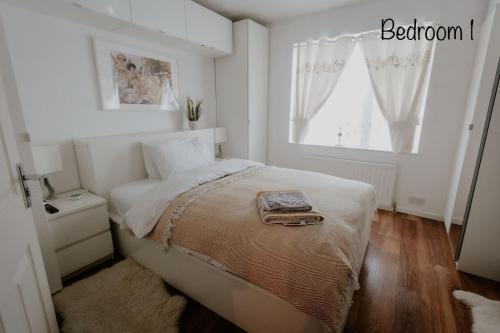 a white bedroom with a bed and a window at Cannock Chase Guest House - Modern Super Spacious Renovated home for 6 guests in Huntington