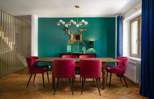 a dining room with a table and red chairs at Close- Golden Villa Saska Kępa - Fully Renovated 2025 in Warsaw