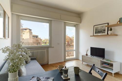 a living room with a couch and a tv at La Sismonda in Rimini