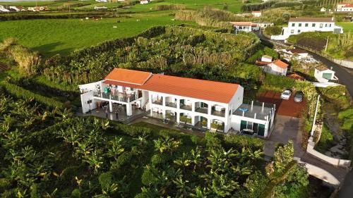 an aerial view of a white house with an orange roof at The Plantation Faial in Feteira