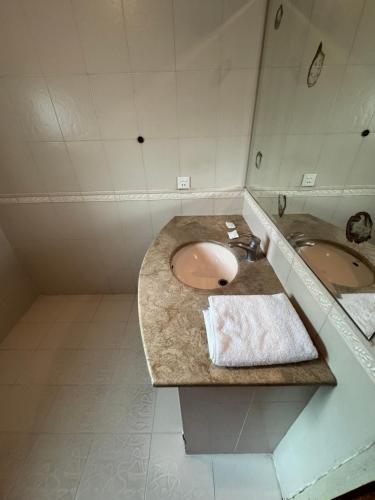 a bathroom with two sinks and a large mirror at City view hotel lawrance road in Lahore