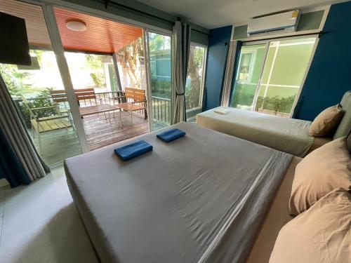 a bedroom with a bed with two blue plates on it at Rayonghouse Resort in Rayong