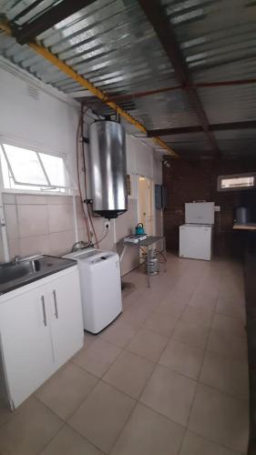 a large kitchen with white appliances in a room at Alhoa 1 in Gariep Dam