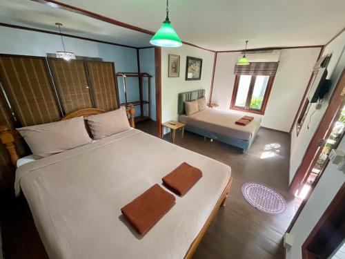 Postel nebo postele na pokoji v ubytování Rayonghouse Resort