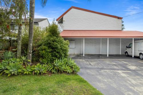 a white van parked in front of a building at Chic 2-Bed Cabin-Style Home by Mooloolaba Beach in Mooloolaba