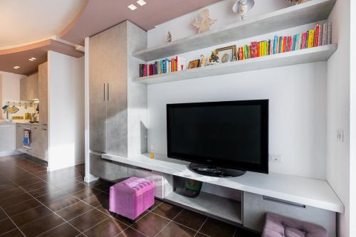 a living room with a flat screen tv on a wall at My Holidays Casa Agata in Gravedona