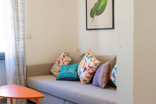 a couch with pillows on it in a living room at Spacious accommodation with fast Wi-Fi and private terrace in Cutrofiano