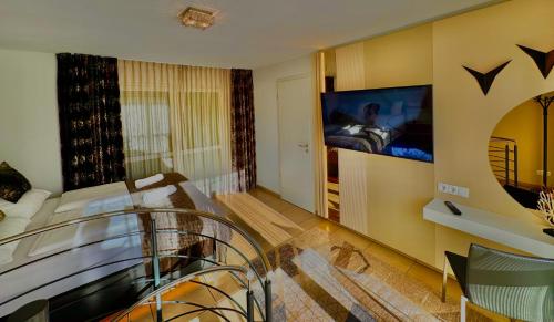 a bedroom with a bed and a tv on a wall at Boardinghouse HOME - adults only - in Konstanz