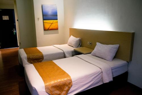 Yunna Hotel Lampungにあるベッド