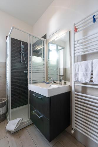 a bathroom with a sink and a shower at My Holidays Casa Adele in Vercana
