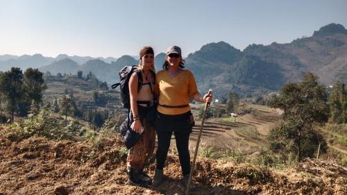 a man and a woman standing on a mountain at Higland Homestay Bac Ha in Bắc Hà