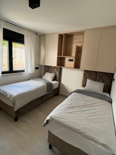 a bedroom with two beds and a window at Theview 1 in Maslenica